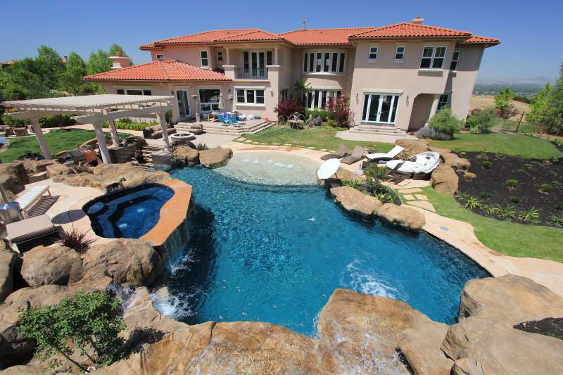 Rock Feature Backyard Swimming Pool and Hot Tub