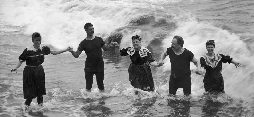 Men and Women Swim in the Surf Wearing Bloomer Suits During the 1800s
