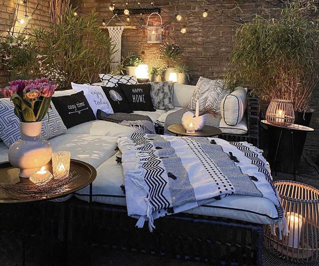 Outdoor Couch Decor with Blanket, Tons of Pillows & Glowing Candles