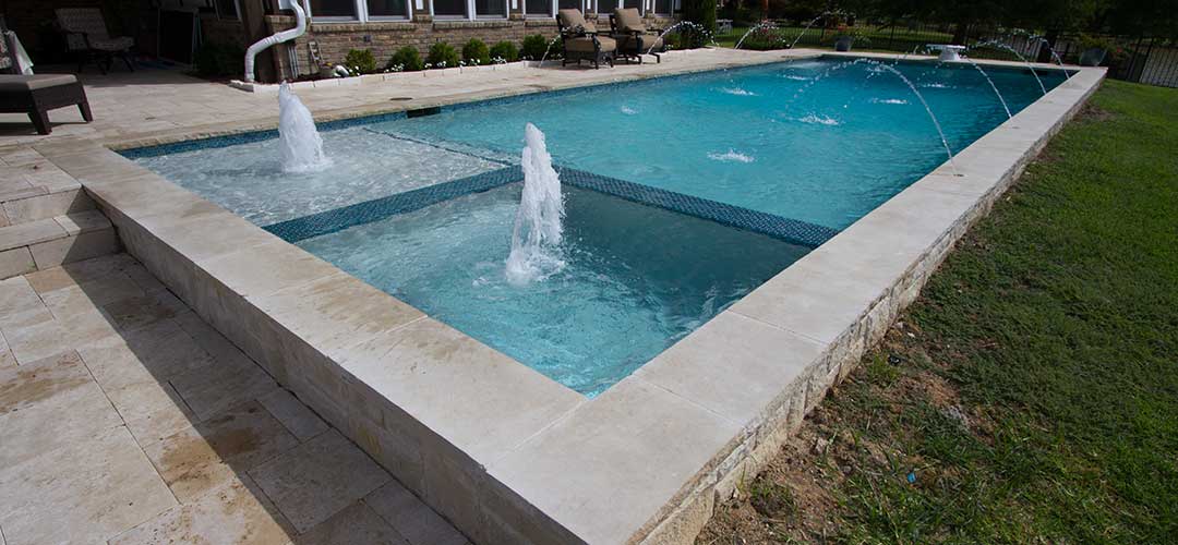 swimming pool with spa and fountain