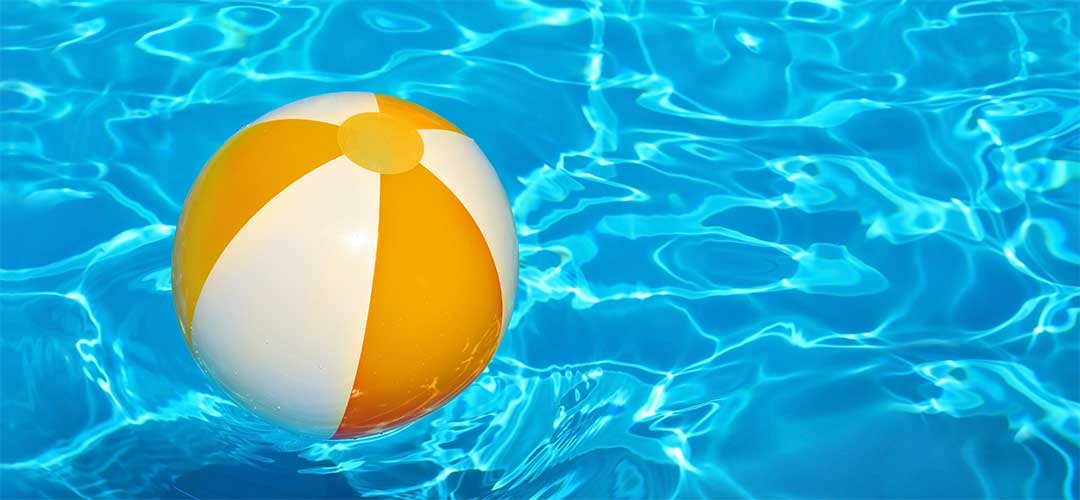 Beach Ball Floating on Pool Water