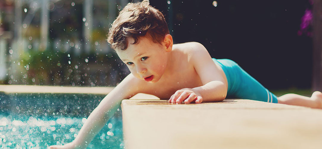 Kid Reaching Into Pool